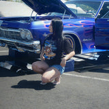 lowrider girl with lowrider shakawear t-shirt next to ss impala